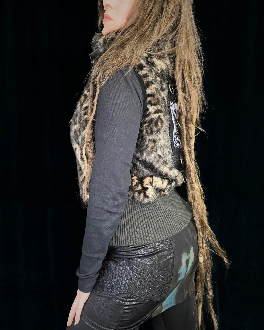 Leo fur vest with stand-up collar, metal appliqués and CAT backpatch