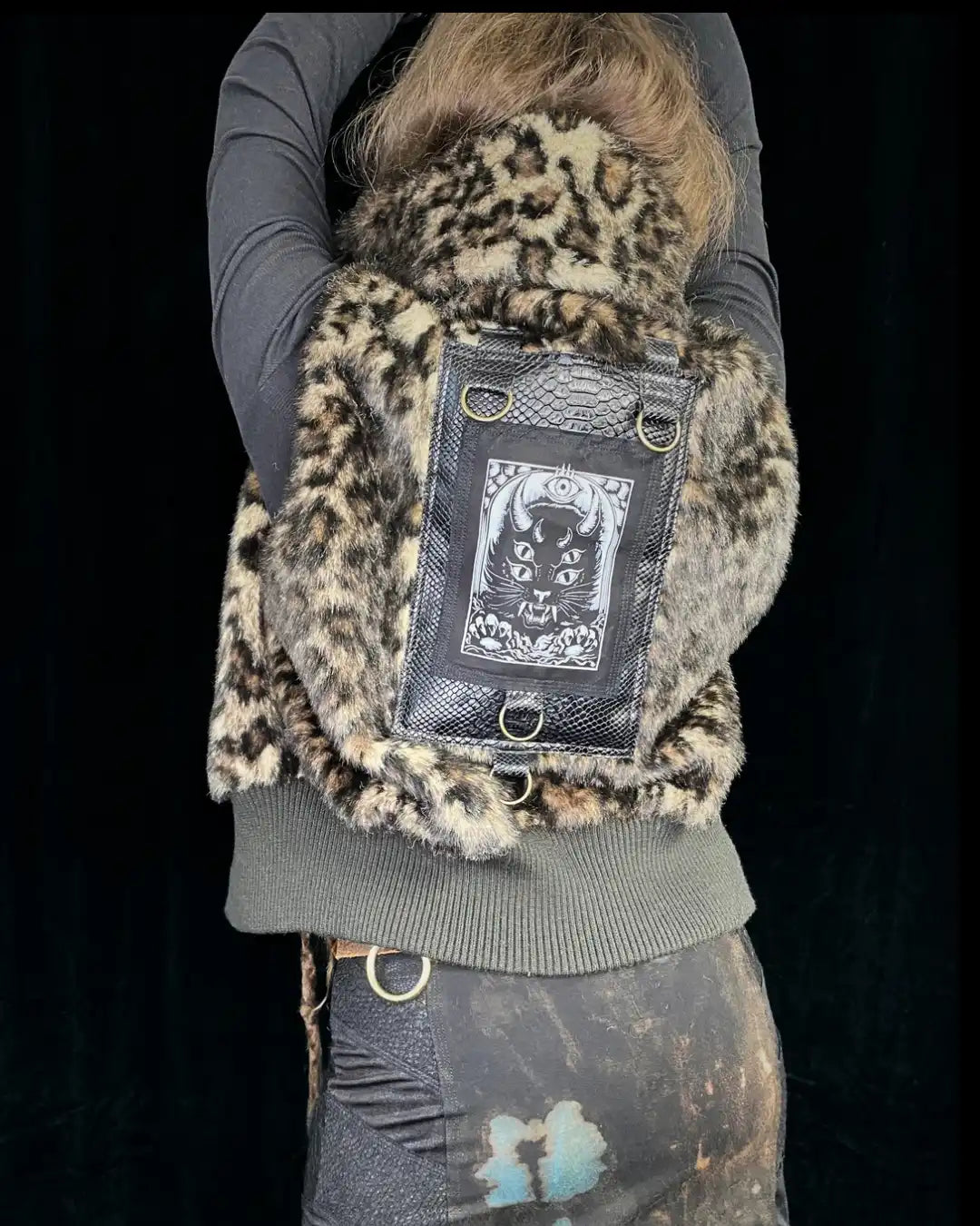 Leo fur vest with stand-up collar, metal appliqués and CAT backpatch