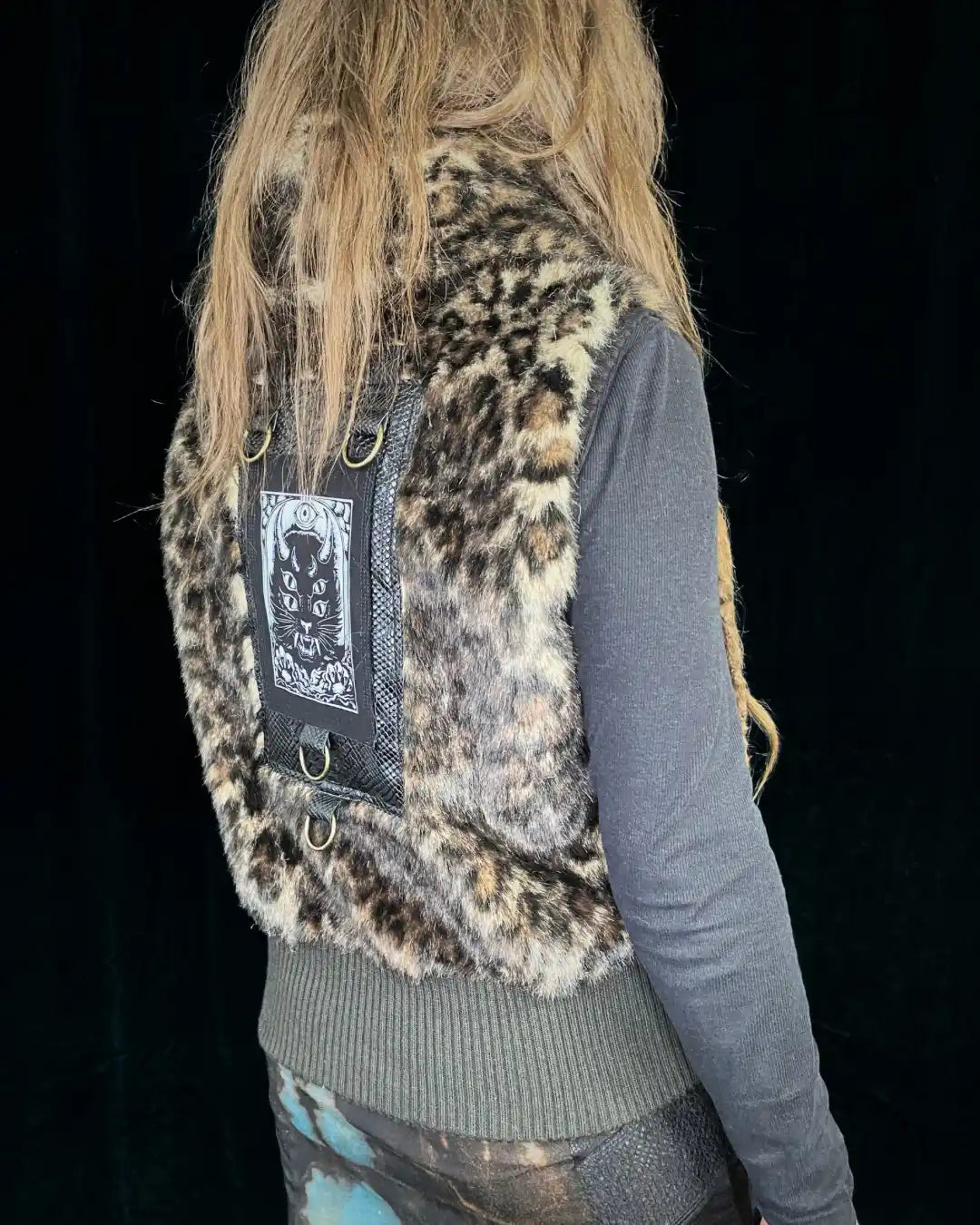 Leo fur vest with stand-up collar, metal appliqués and CAT backpatch