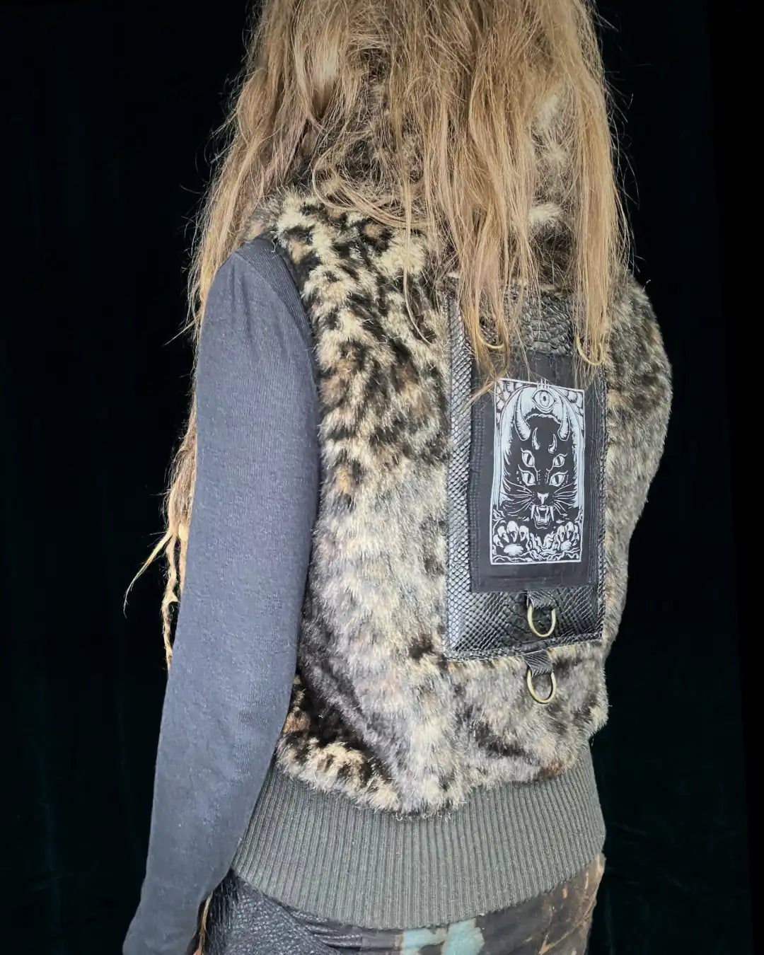 Leo fur vest with stand-up collar, metal appliqués and CAT backpatch
